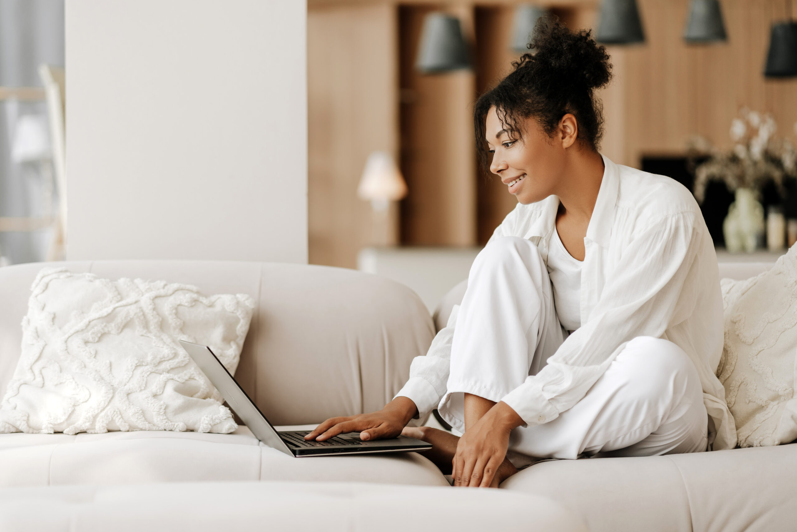 Woman relaxing on a sofa using a laptop